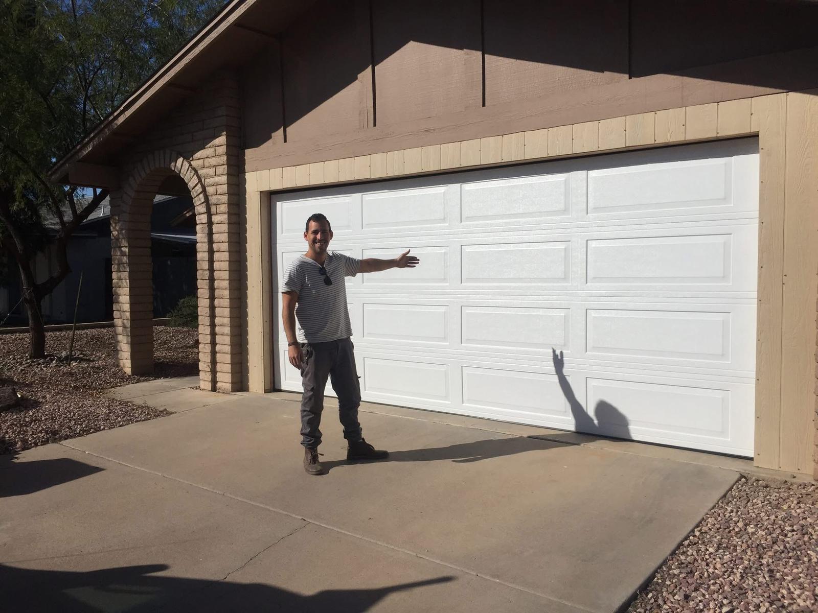 New residential garage door installation in Phoenix AZ featuring a durable insulated sectional garage door installed by local garage door professionals.