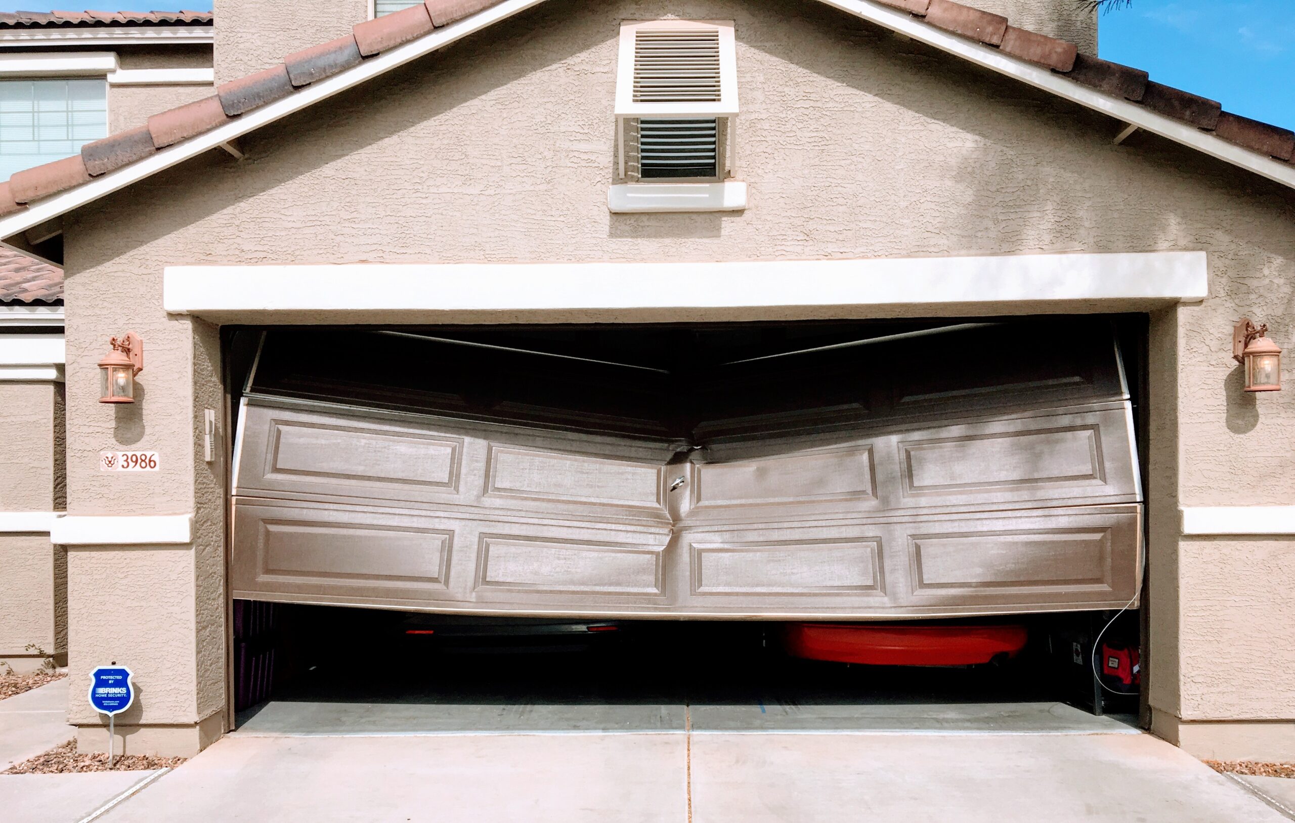 Emergency garage door repair in Phoenix AZ for severely damaged and collapsed residential garage doors caused by vehicle impact or structural failure.